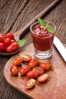 closeup a glass of ketchup and tomatoes