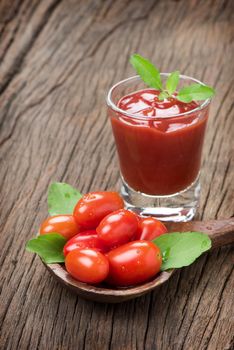 closeup a glass of ketchup and tomatoes