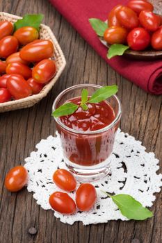 closeup a glass of ketchup and tomatoes