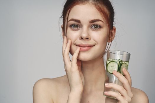 woman with cucumber drink health vitamins close-up. High quality photo