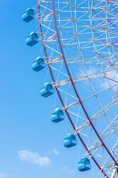 closeup ferris wheel against blue sky