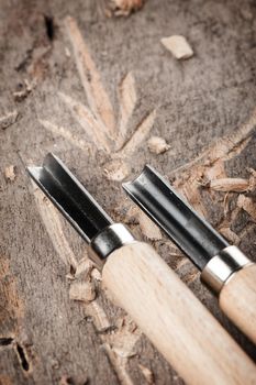 closeup chisels for wood on carpenter desktop