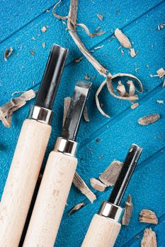 closeup chisels for wood on blue background