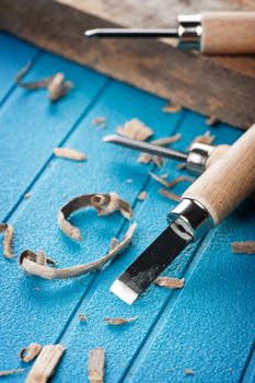 closeup chisels for wood on blue background