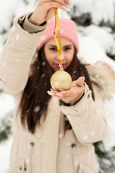 Merry Christmas and happy New Year. Beautiful woman in warm winter clothes holding christmas decoration