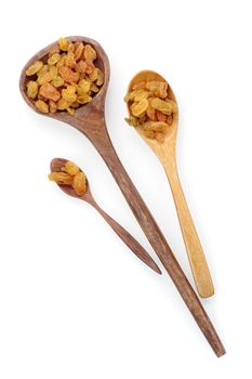 closeup heap of delicious raisins on wooden spoon