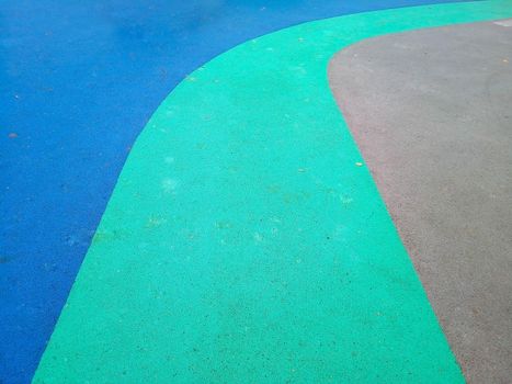 Colorful playground background. Grey-blue rubber outdoor playground.