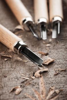closeup chisels for wood on carpenter desktop