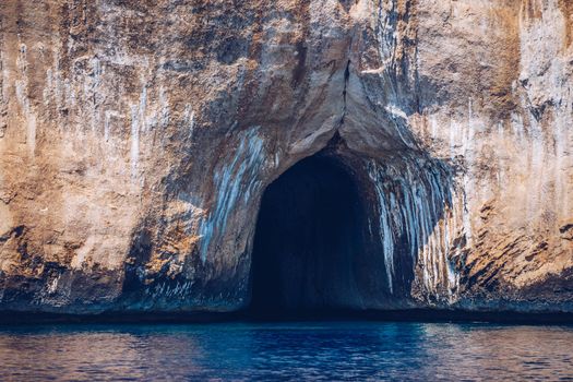Blue sea and the characteristic caves of Cala Luna, a beach in the Golfo di Orosei, Sardinia, Italy. Big sea caves in the mediterranean coast. Sardinia, Italy.