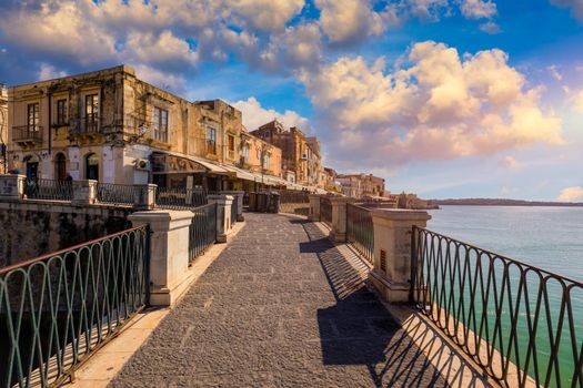 The Fountain of Arethusa and Siracusa (Syracuse) in a sunny summer day. Sicily, Italy. The Fountain of Arethusa in Ortygia, historical centre of Syracuse, Sicily, Italy.