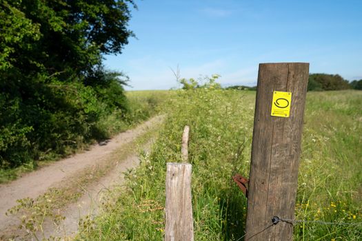 WIPPERFURTH, GERMANY - JUNE 19, 2021: Long distance hiking trail Bergischer Panoramasteig with focus on the typical waymark on June 19, 2021 in Germany