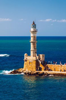 Panorama of venetian harbour waterfront and lighthouse in old harbour of Chania, Crete, Greece. Old venetian lighthouse in Chania, Greece. Lighthouse of the old Venetian port in Chania, Greece.