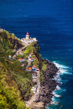 Dramatic view down to lighthouse on Ponta do Arnel, Nordeste, Sao Miguel Island, Azores, Portugal. Lighthouse Arnel near Nordeste on Sao Miguel Island, Azores, Portugal. 