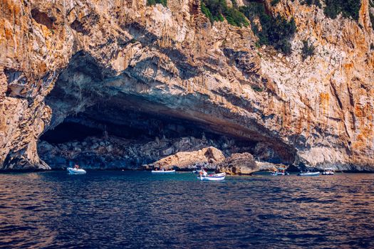 Blue sea and the characteristic caves of Cala Luna, a beach in the Golfo di Orosei, Sardinia, Italy. Big sea caves in the mediterranean coast. Sardinia, Italy.
