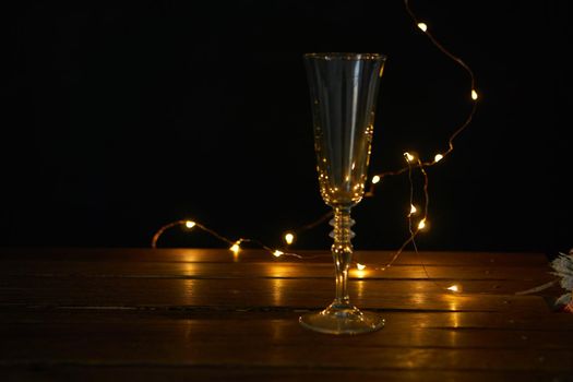 christmas decoration champagne glasses garland holiday wooden table. High quality photo