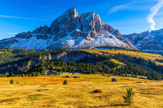 Stunning view of Peitlerkofel mountain from Passo delle Erbe in Dolomites, Italy. View of Sass de Putia (Peitlerkofel) at Passo delle Erbe, with wooden farm houses, Dolomites, South Tyrol, Italy.