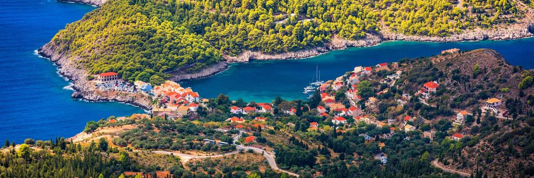 Assos village in Kefalonia, Greece. Turquoise colored bay in Mediterranean sea with beautiful colorful houses in Assos village in Kefalonia, Greece, Ionian island, Cephalonia, Assos village.