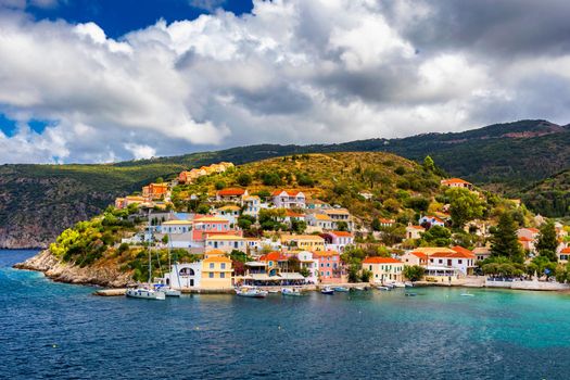 Assos village in Kefalonia, Greece. Turquoise colored bay in Mediterranean sea with beautiful colorful houses in Assos village in Kefalonia, Greece, Ionian island, Cephalonia, Assos village.