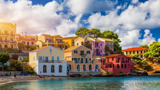 Turquoise colored bay in Mediterranean sea with beautiful colorful houses in Assos village in Kefalonia, Greece. Town of Assos with colorful houses on the mediterranean sea, Greece. 
