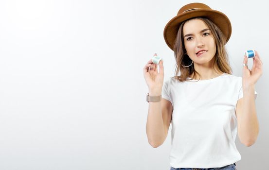 Happy girl in hat with coils of threads near eyes. High quality photo