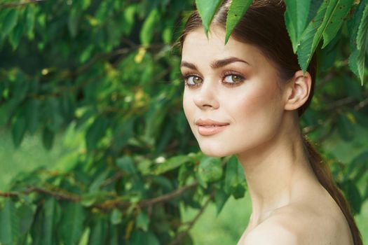 portrait of a woman Cosmetology nature green leaves glamor cropped view. High quality photo