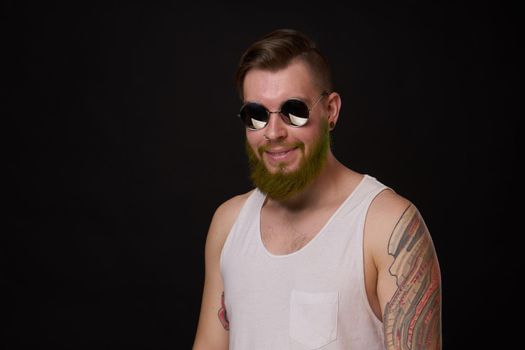 cheerful bearded man in white t-shirt sunglasses posing. High quality photo