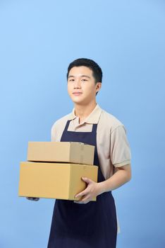 Asian smart handsome male holding boxes for delivery to customers