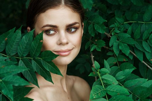 smiling woman green leaves clean skin nature summer model. High quality photo