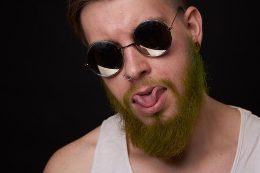 cheerful bearded man in white t-shirt sunglasses posing. High quality photo