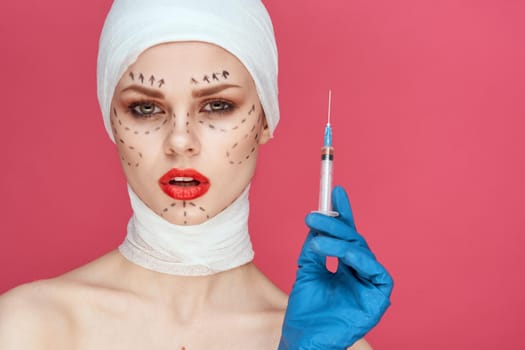 woman posing in blue gloves red lips surgery facial rejuvenation pink background. High quality photo