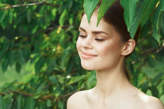 beautiful woman attractive look bare shoulders green leaves Lifestyle. High quality photo