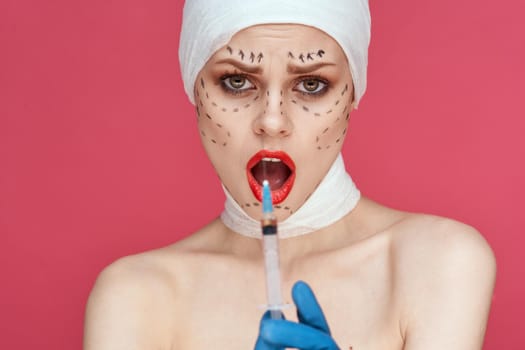 woman posing in blue gloves red lips surgery facial rejuvenation pink background. High quality photo