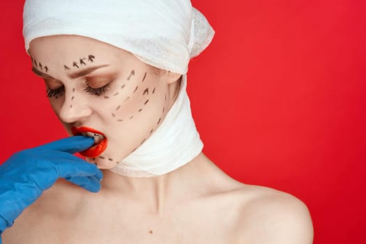 female patient posing in blue gloves red lips surgery facial rejuvenation isolated background. High quality photo