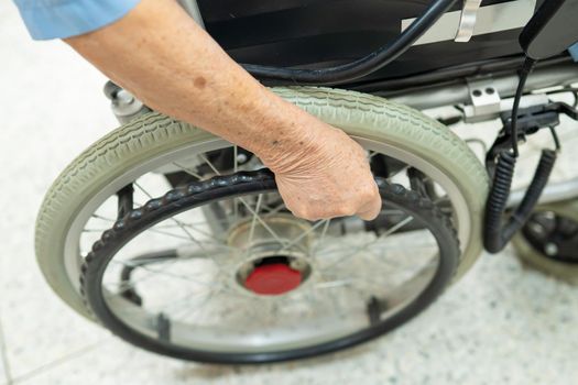 Asian senior or elderly old lady woman patient on electric wheelchair with remote control at nursing hospital ward, healthy strong medical concept