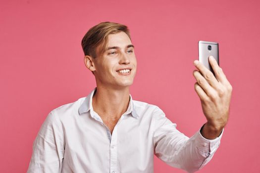 portrait of a man with a phone in hand fashion posing studio lifestyle. High quality photo