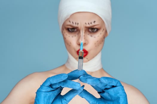female patient posing in blue gloves red lips surgery facial rejuvenation close-up. High quality photo