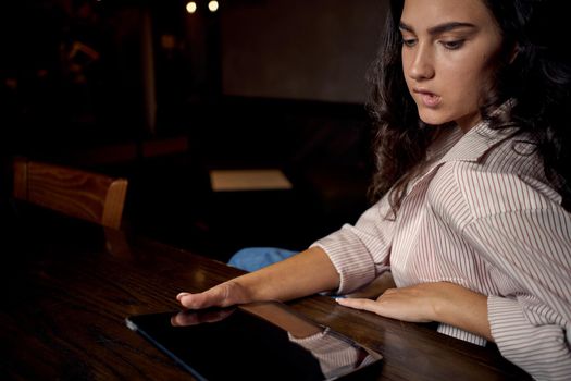 pretty woman in cafe in front of laptop working technology. High quality photo