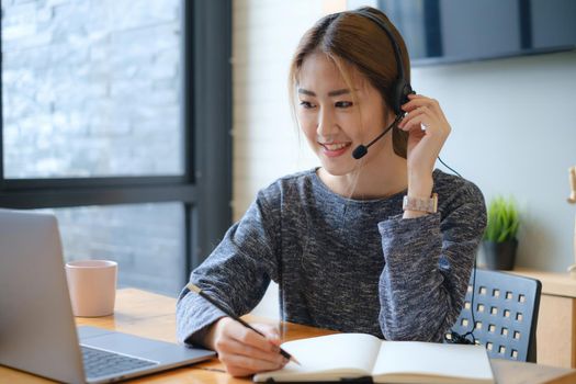 Businesswoman in having a video call on laptop while discussion with business partner during work from home. Support concept.