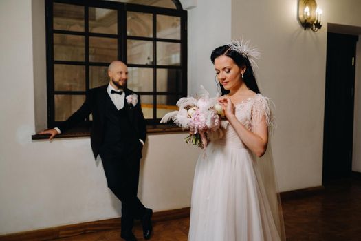 Elegant wedding couple in the interior of the old castle in the city of Nesvizh.