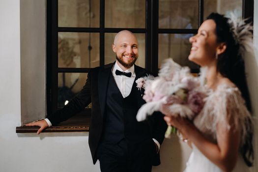 Elegant wedding couple in the interior of the old castle in the city of Nesvizh.