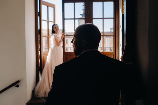 Elegant wedding couple on the balcony of an old castle in the city of Nesvizh.