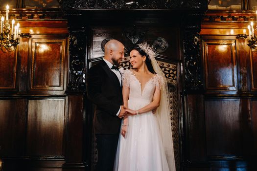 Elegant wedding couple in the interior of the old castle in the city of Nesvizh.