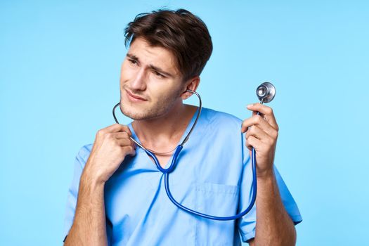 man in medical uniform health care treatment stethoscope examination blue background. High quality photo