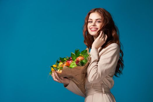 pretty woman smile posing fruit bouquet vitamins blue background. High quality photo