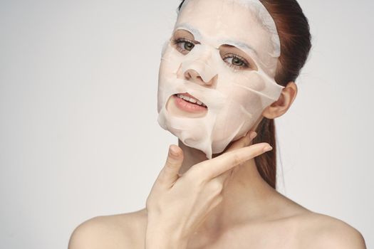 pretty woman naked shoulders face mask close-up skin care. High quality photo