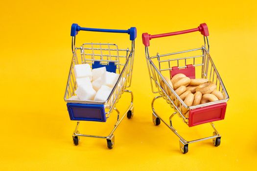 carts with groceries shopping supermarket store yellow background. High quality photo