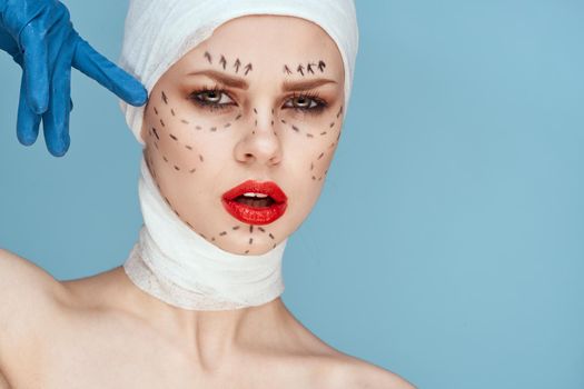 female patient Red lips plastic surgery operation bare shoulders blue background. High quality photo