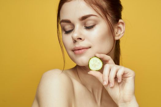 cheerful woman with cucumber vitamin skin care natural product. High quality photo