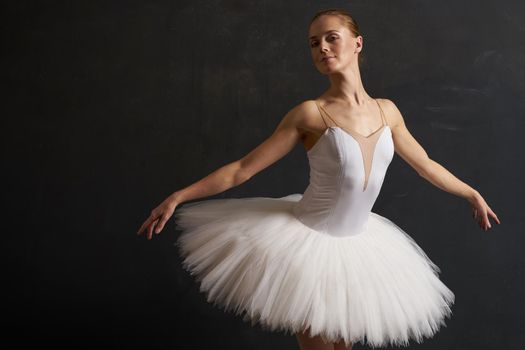 ballerina in a white tutu dance performance silhouette dark background. High quality photo