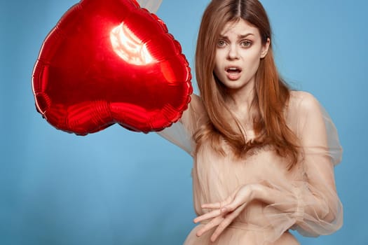 pretty woman red heart in the hands of the balloon isolated background. High quality photo